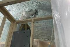 spray foam tiny house being installed on ceiling